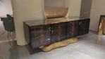 Luxury TV Stand with Bold Stone Top Textured Dark Finish Sculptural Stainless Steel Base and Cabinet Storage